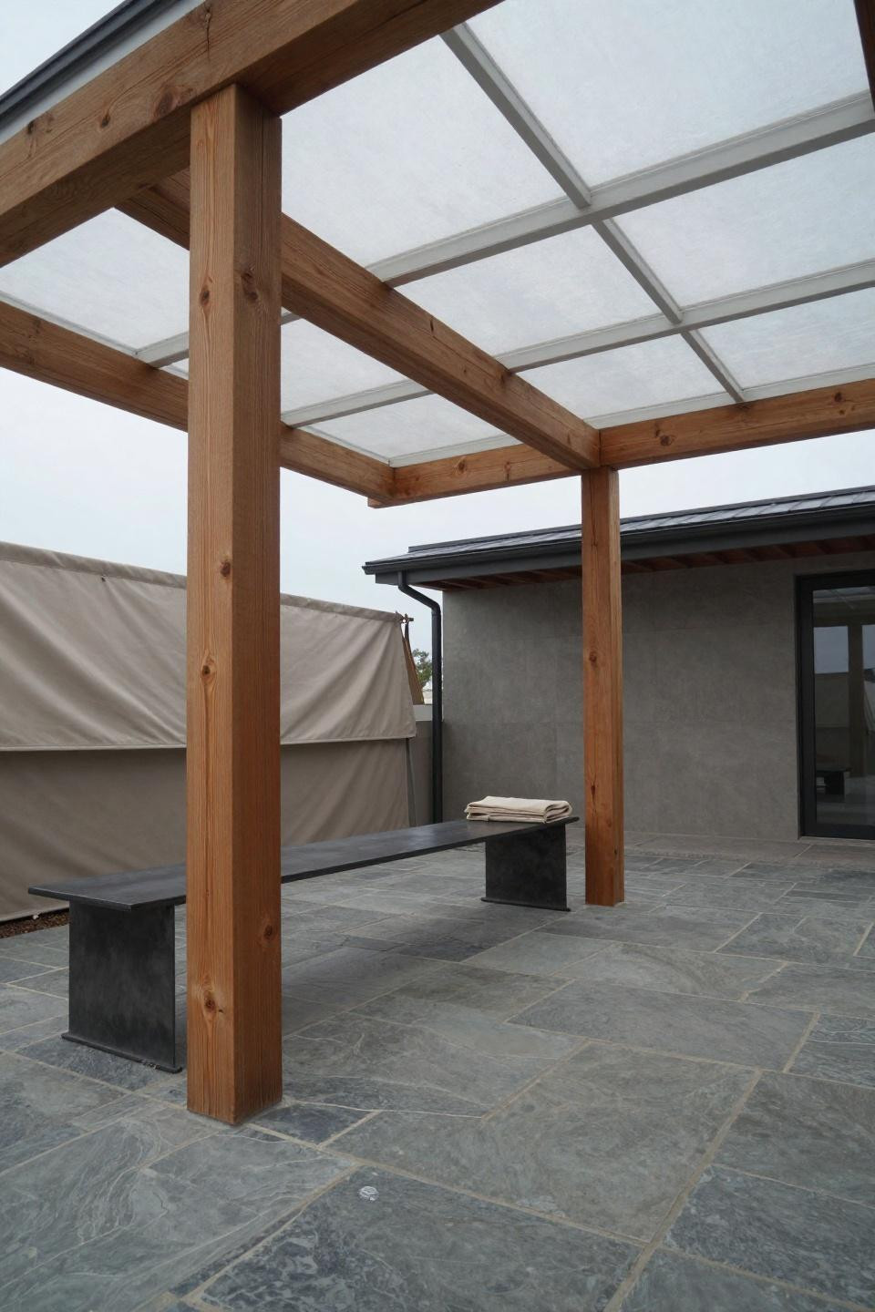 DIY covered patio with exposed Douglas fir timber frame and diffused lighting
