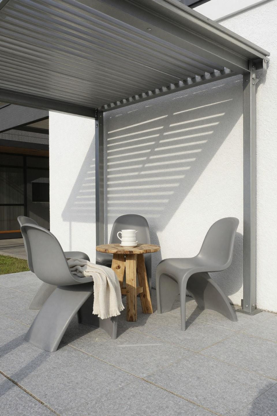 Covered back patio with precision aluminum louvers and Scandinavian furniture
