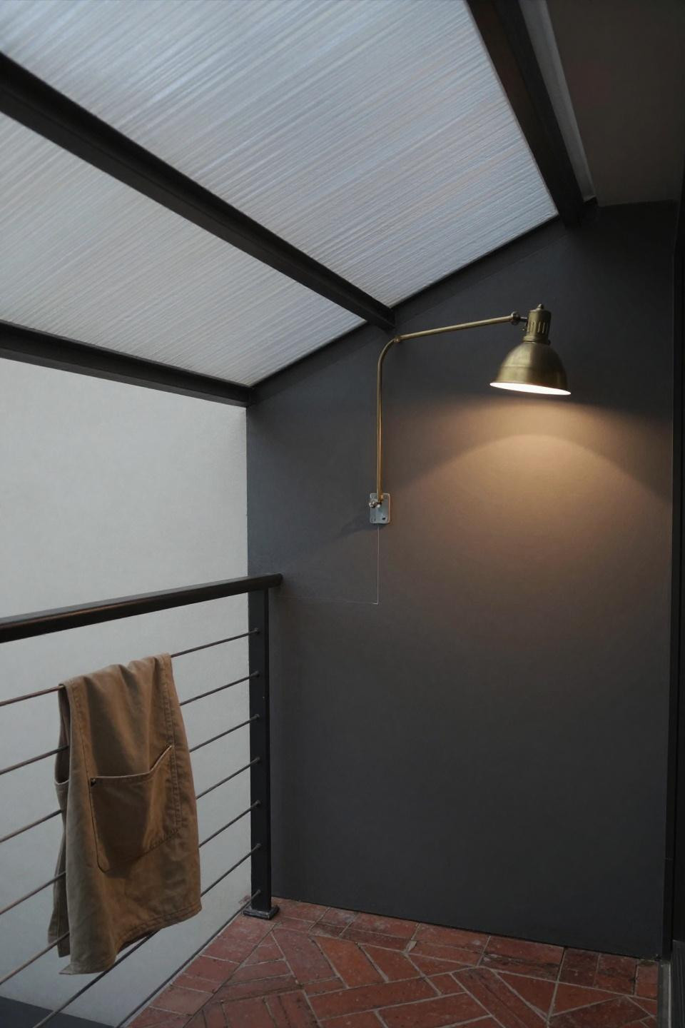 Covered patios attached to house with translucent corrugated fiberglass roof and cable railing