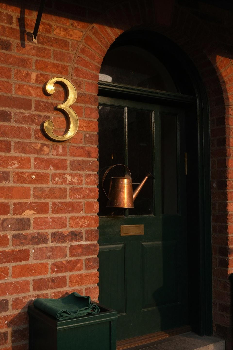 Small front porch ideas with forest green planters and aged brick