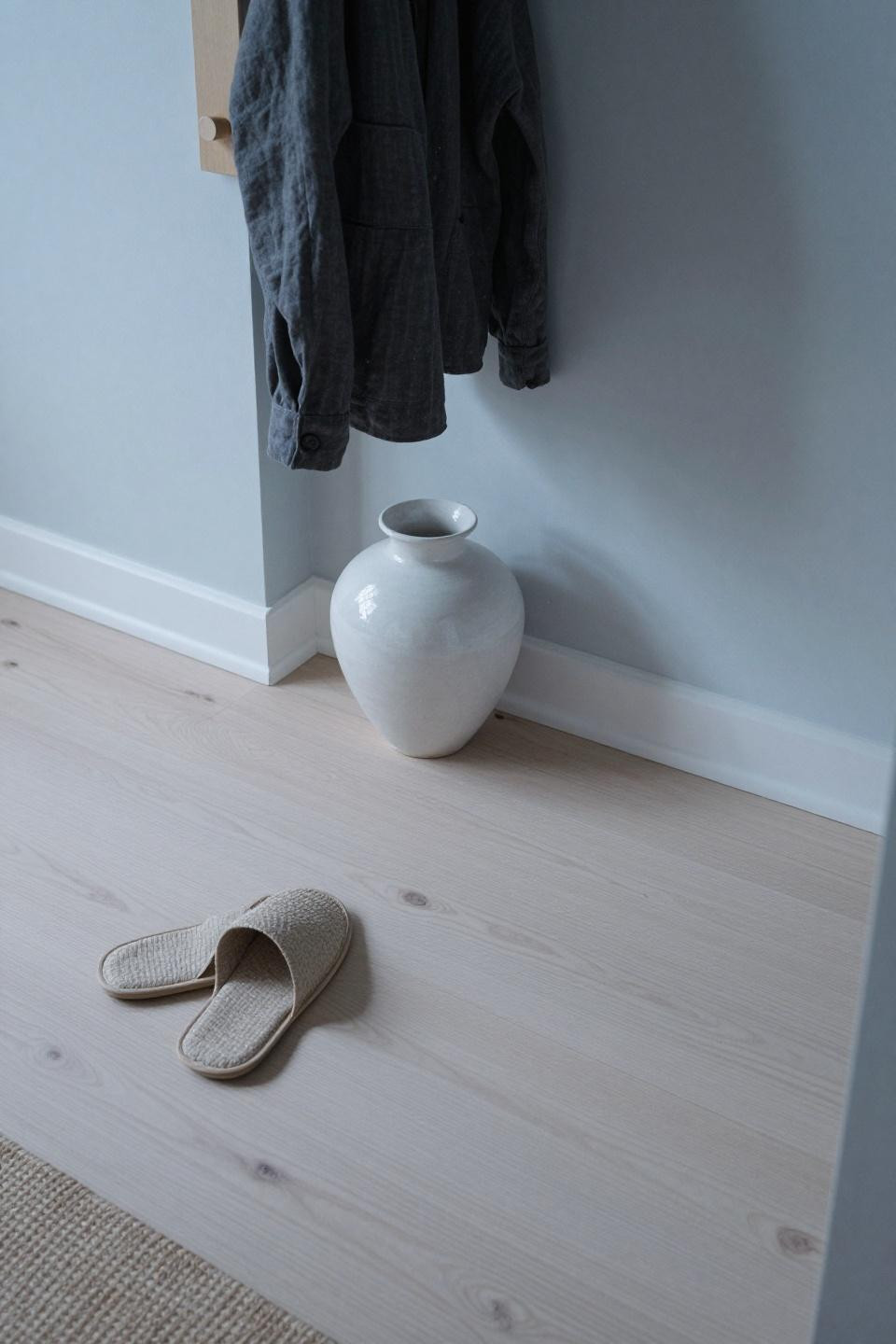 Natural white oak floors in Japandi entryway with minimalist vessel