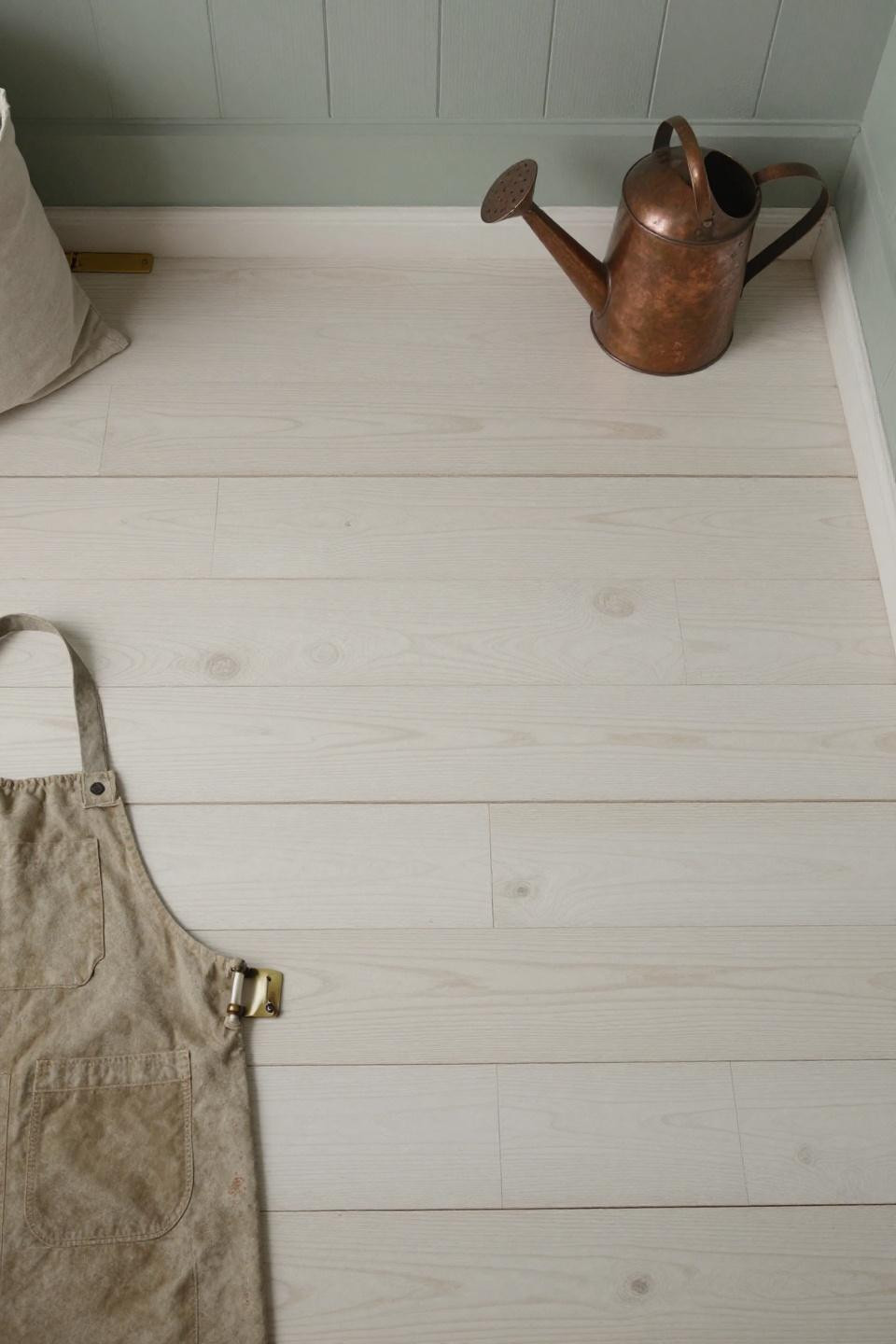Blonde wood floors in rustic farmhouse mudroom with random-width white oak