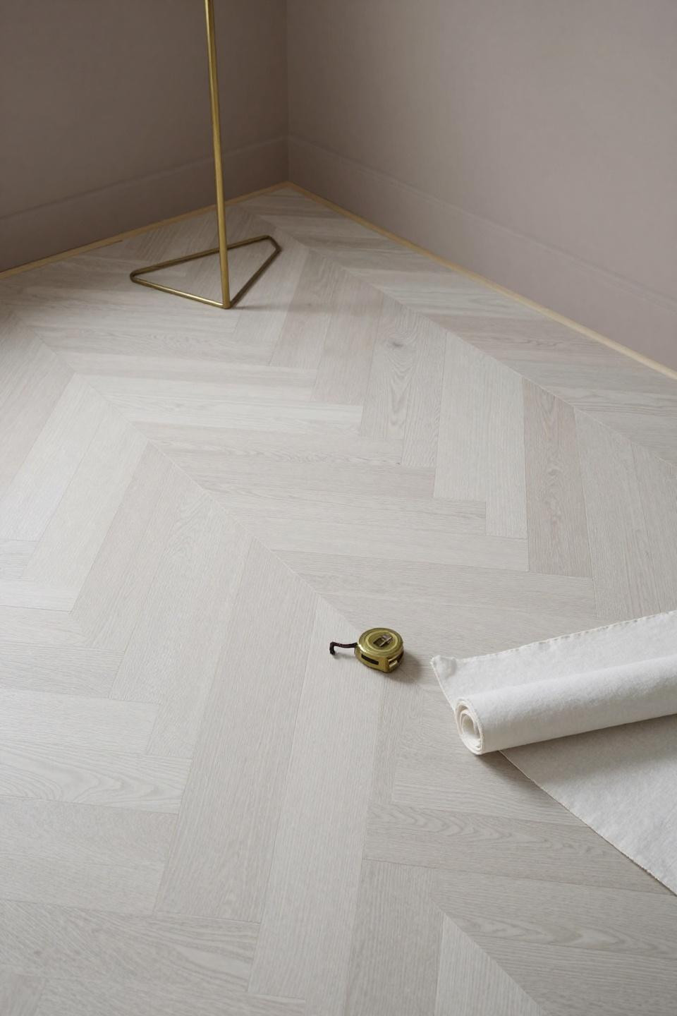 Oak wood flooring in chevron pattern for transitional boutique showroom