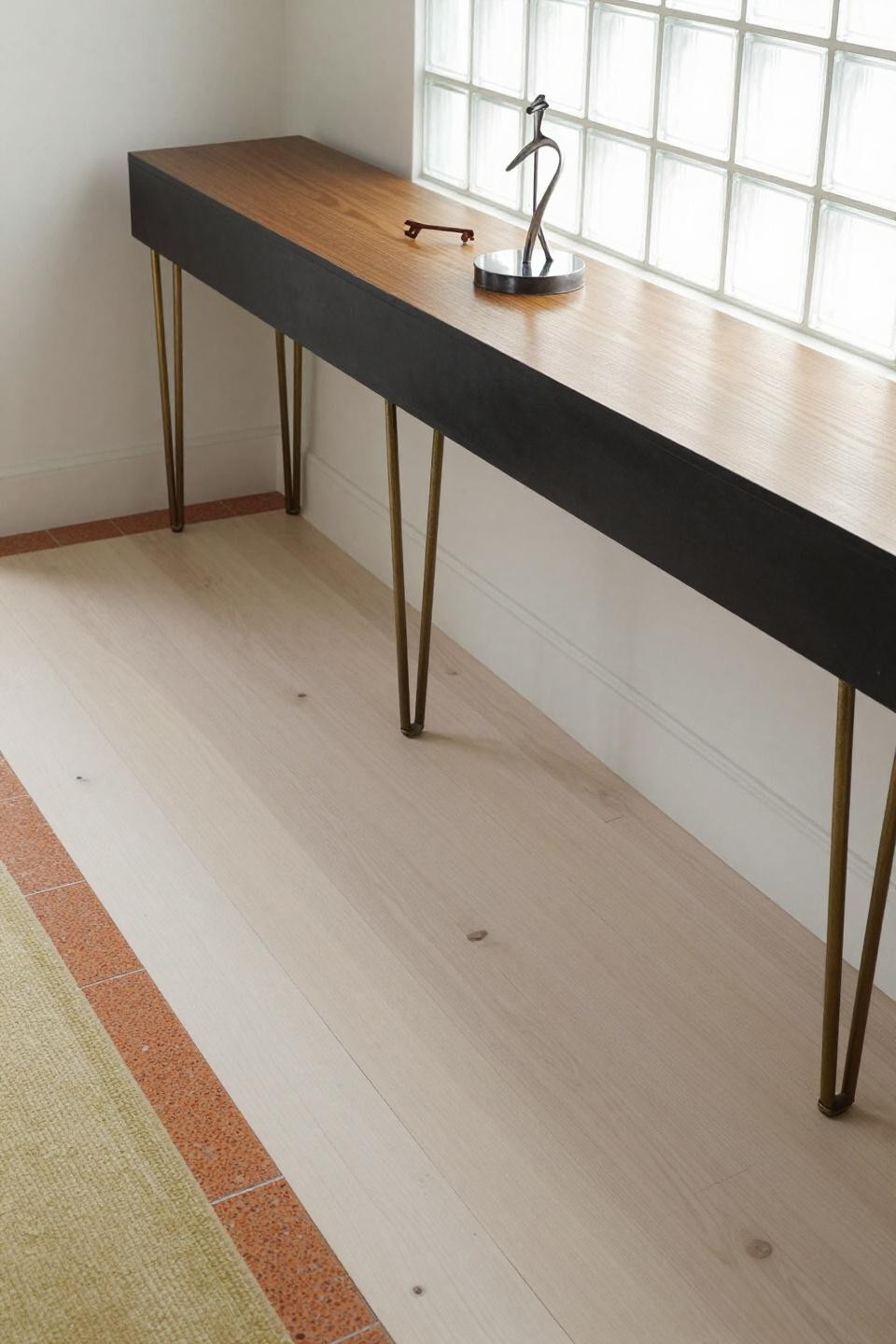 White oak hardwood floors in 1970s ranch entry with bright white light