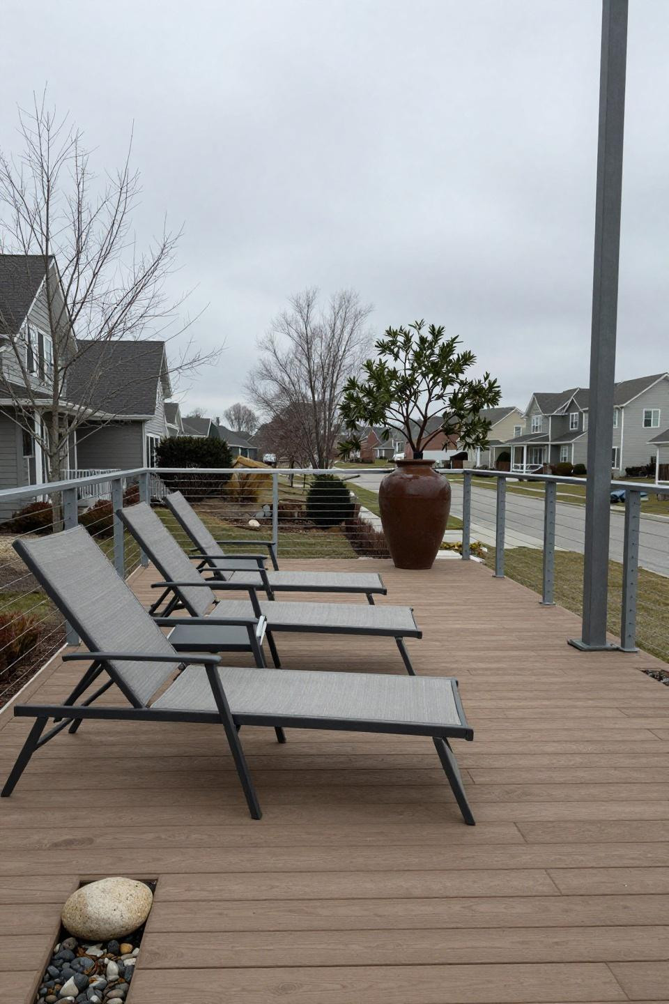Outdoor ideas backyard featuring composite deck and weathered aluminum lounge chairs