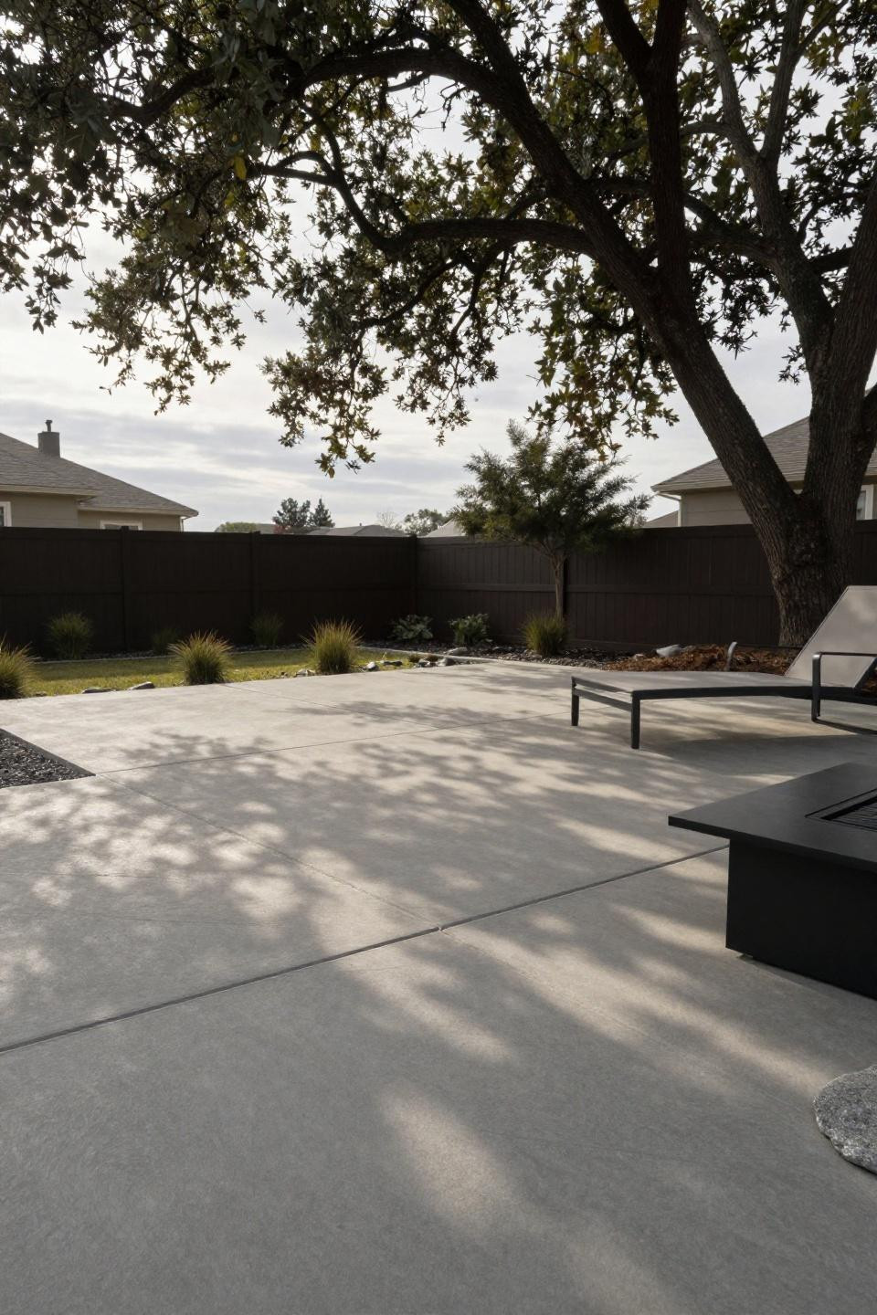 Modern stamped concrete patio with geometric linear pattern and fire feature