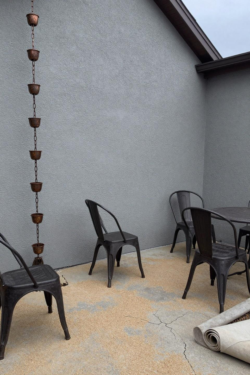Modern stamped concrete patio in narrow side yard with broom texture