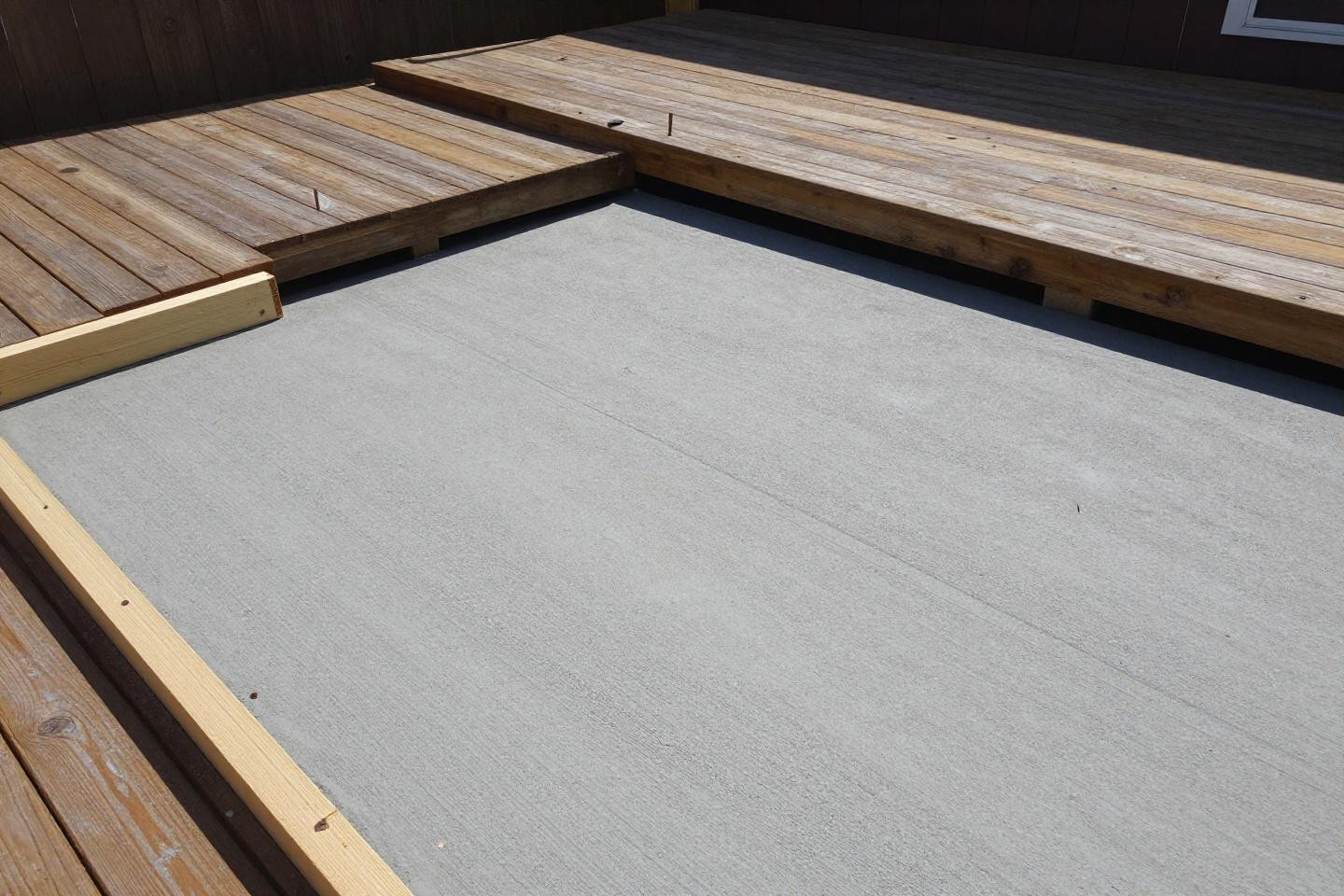 DIY patio design ideas showing fresh broom-finish concrete mid-construction