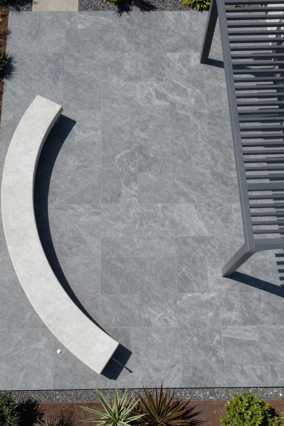 Outdoor paver patio ideas showing expansive ashlar block pattern in slate grey