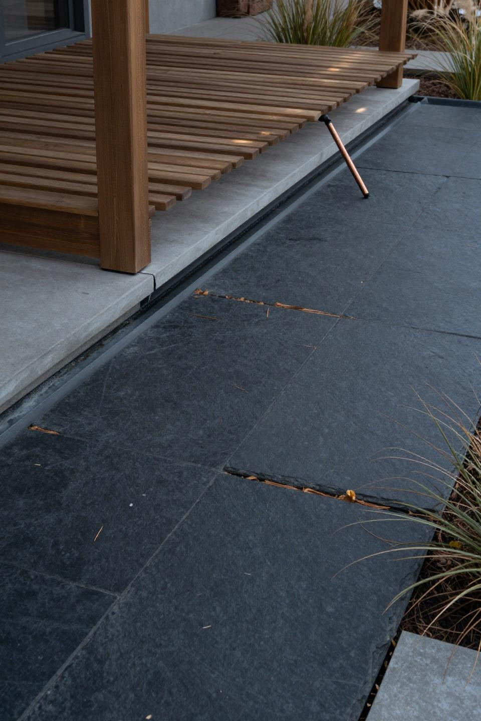 Backyard concrete patio ideas with charcoal slate flagstone impression and modern pergola