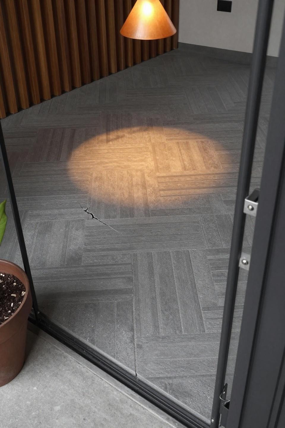 Modern stamped concrete patio with graphite basketweave pattern and industrial lighting