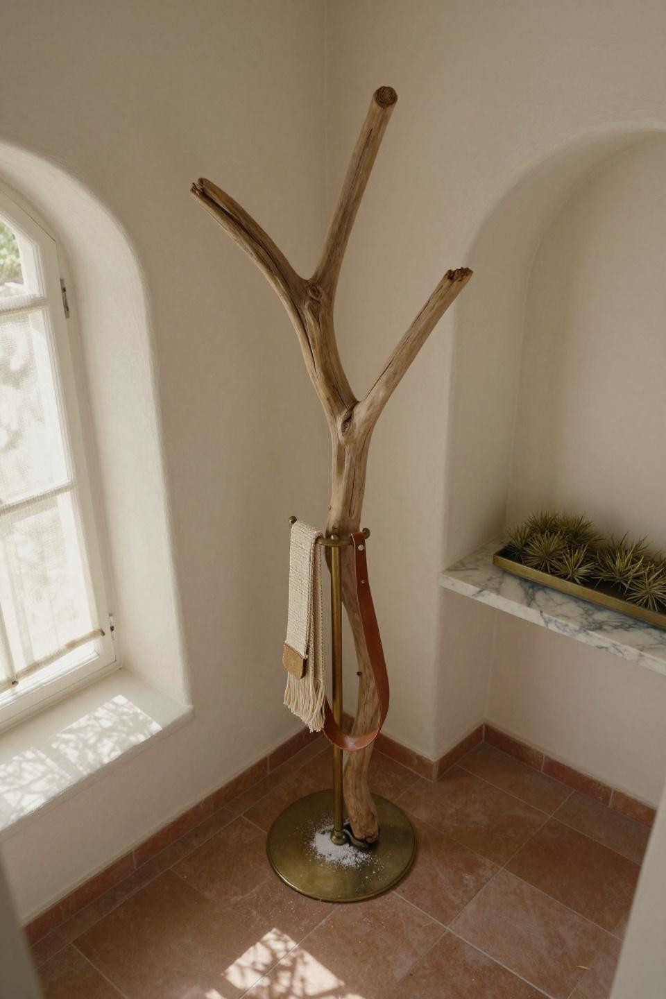 Tall sculptural driftwood branch in brass floor stand with leather loops