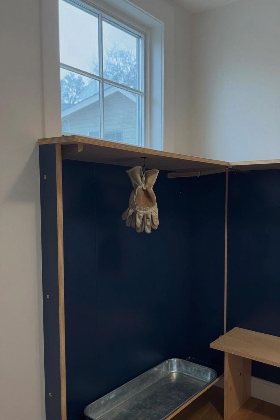 DIY plywood coat storage with exposed finger joints and dowel pegs