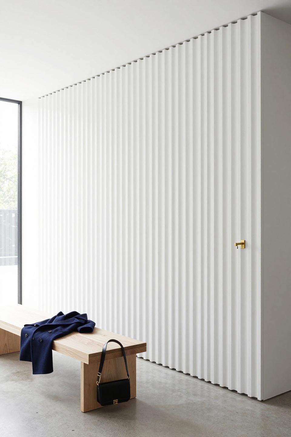 Entry coat rack ideas with white oak slats and unlacquered brass hooks