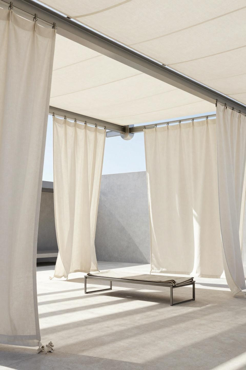 Outside curtains in cream linen suspended from ceiling track system