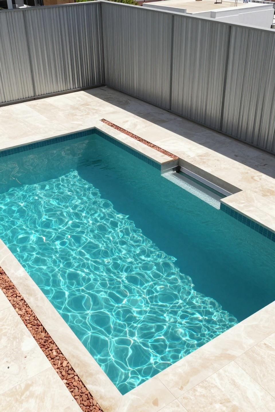 Rectangle pool with geometric split-level design and steel edge-banding