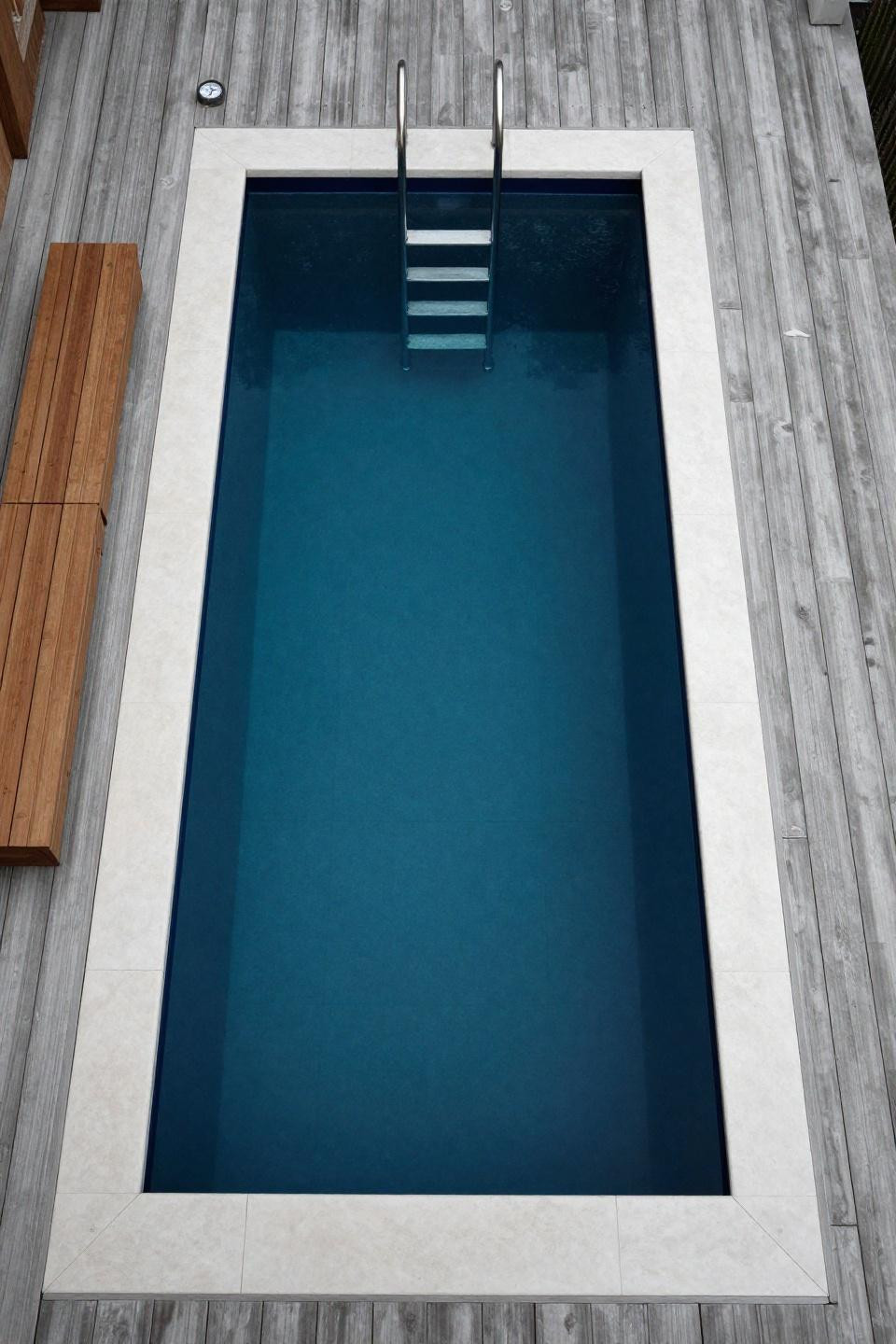 Above pool landscaping ideas with midnight blue liner and walnut bench