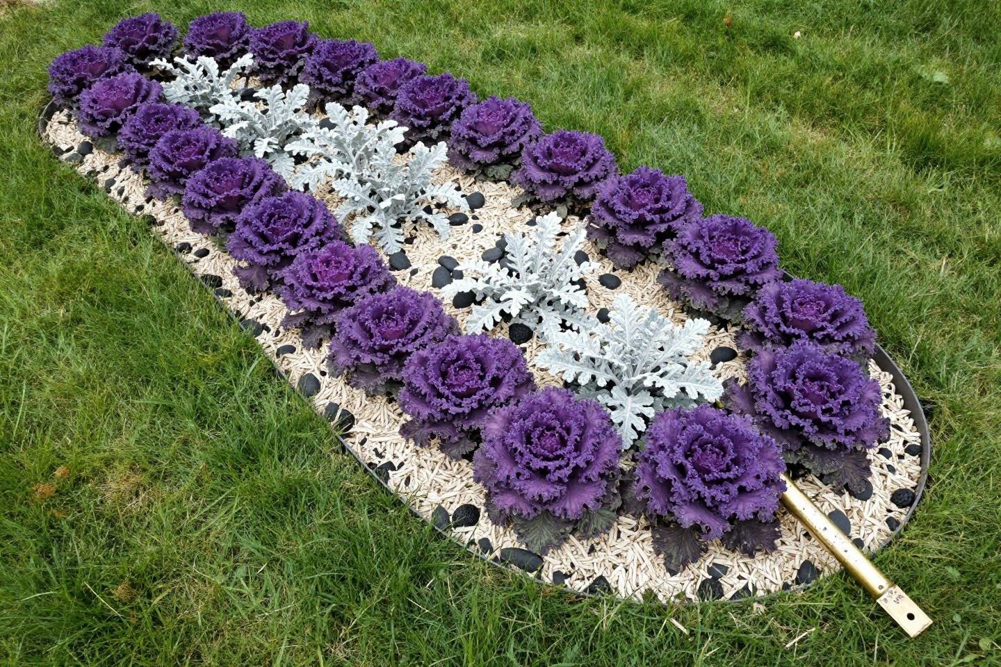 Front of house landscape ideas featuring curved composite raised bed