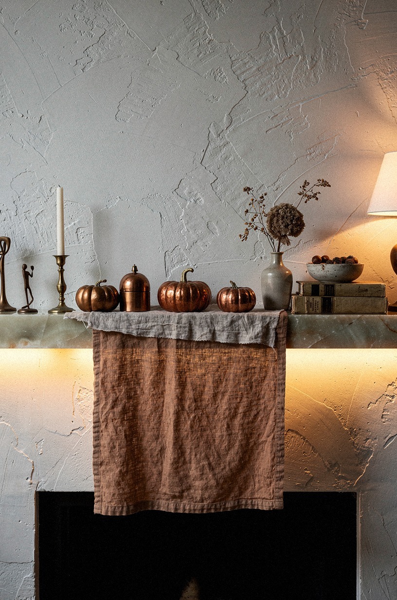 Layer rough linen beneath copper pumpkins