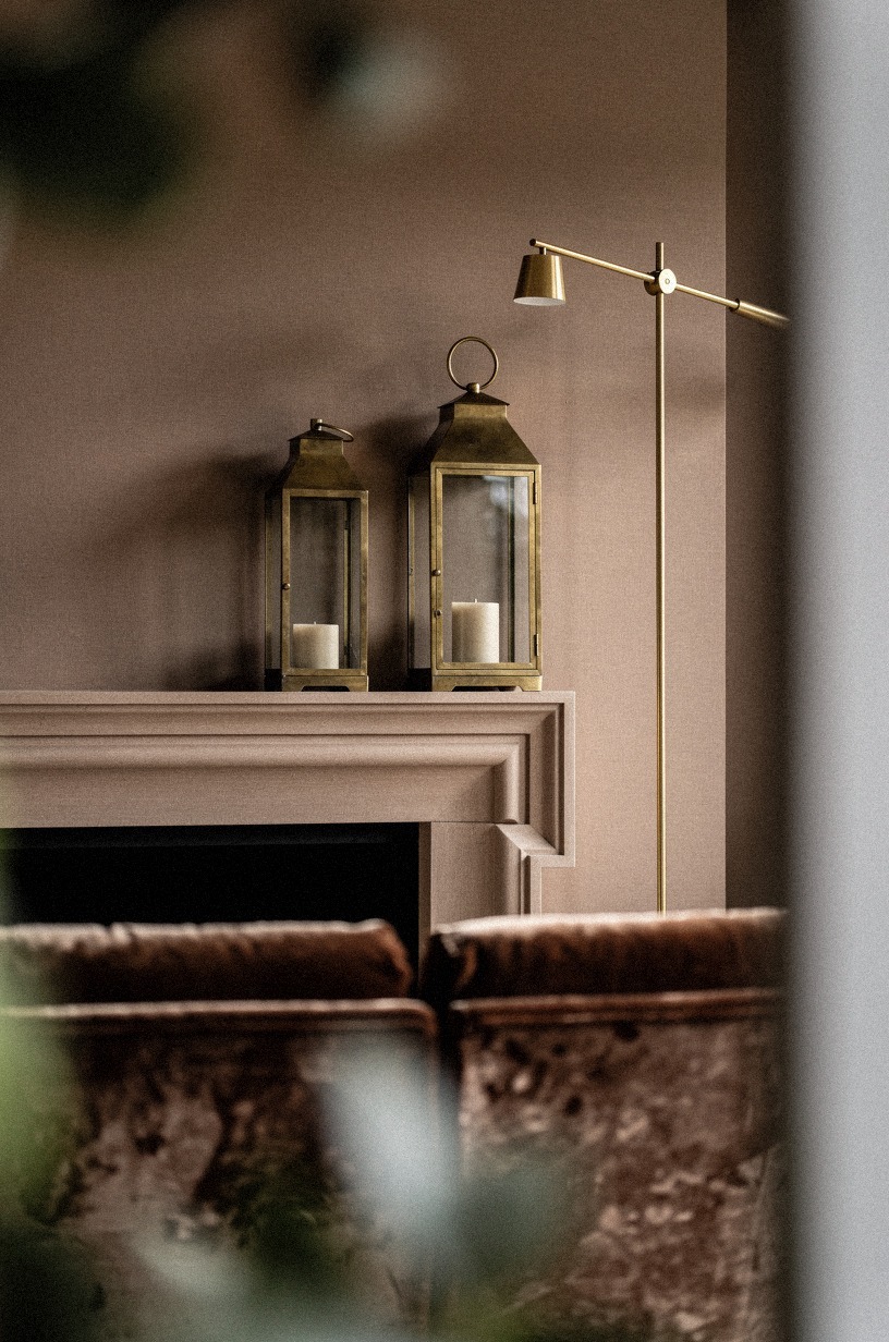 How do oversized brass lanterns anchor a mantel?