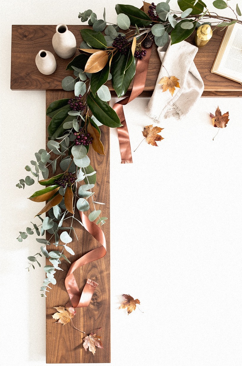 Layer magnolia garland over muted eucalyptus stems