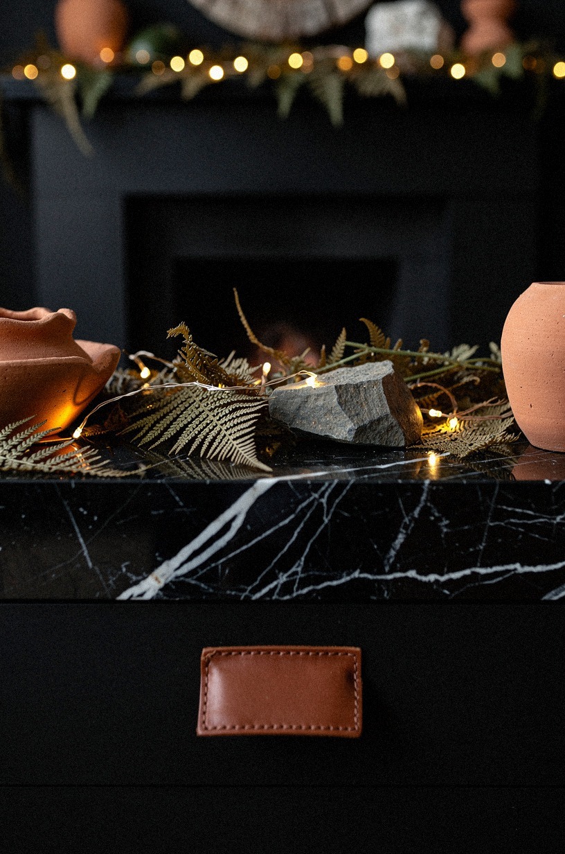 Tuck amber fairy lights under dried ferns