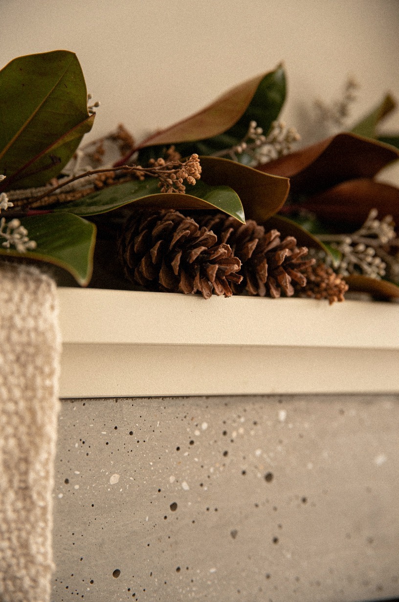 Add pinecones under the lowest garland dips