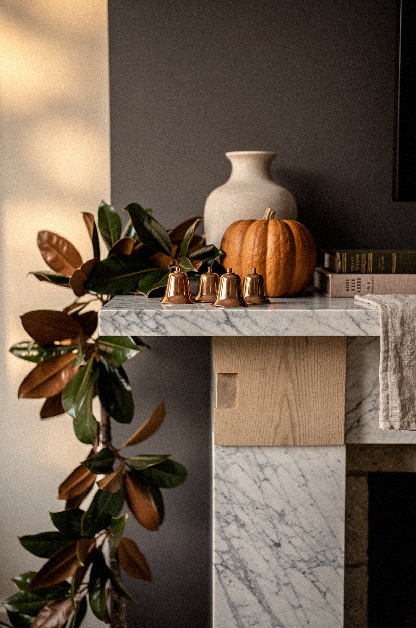 Place copper bells beside the pumpkin cluster