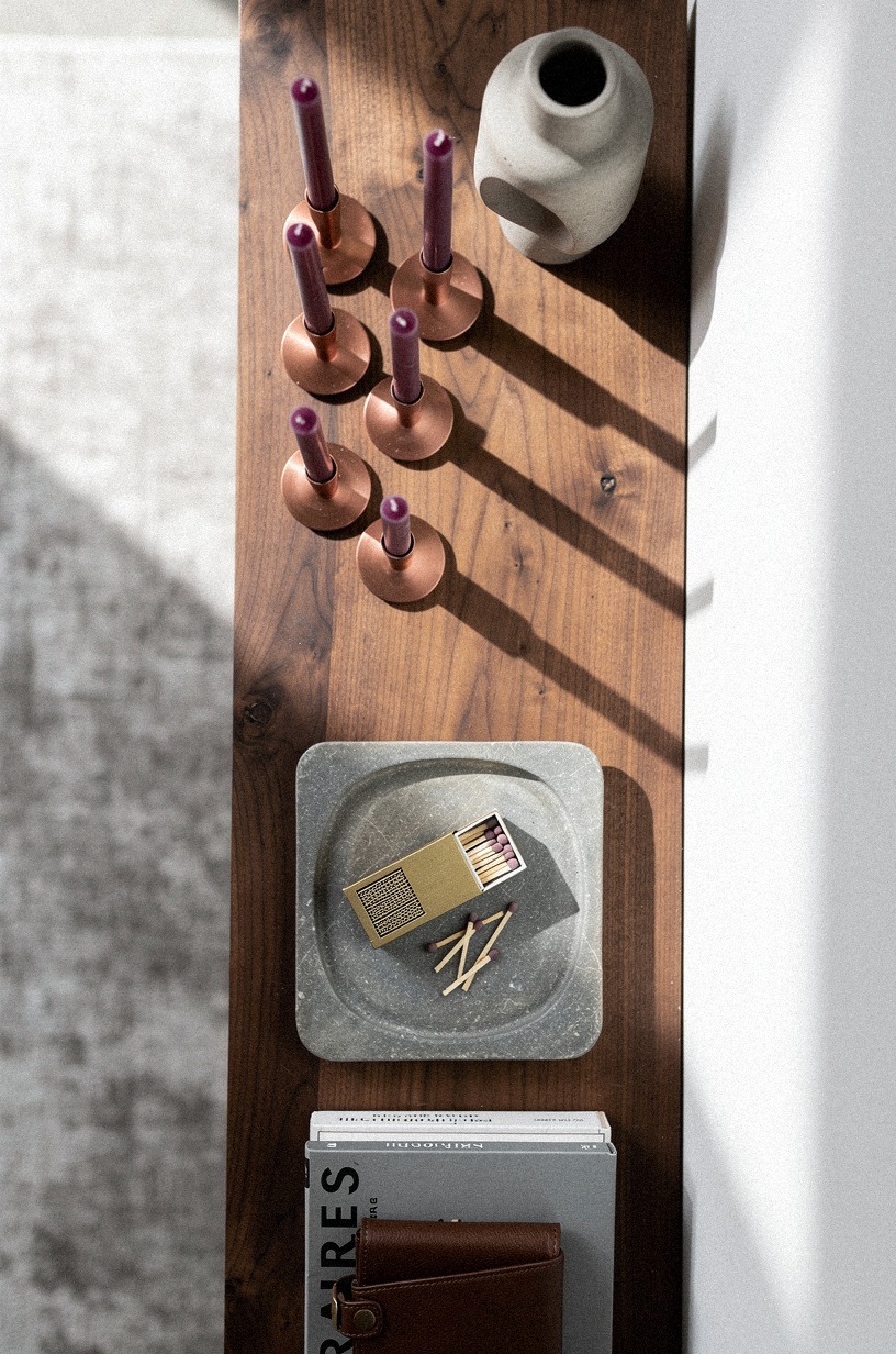 Layer slim candlesticks across the mantel shelf