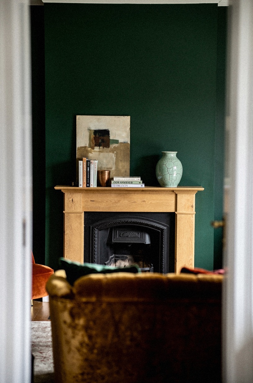 Lean small art behind stacked books
