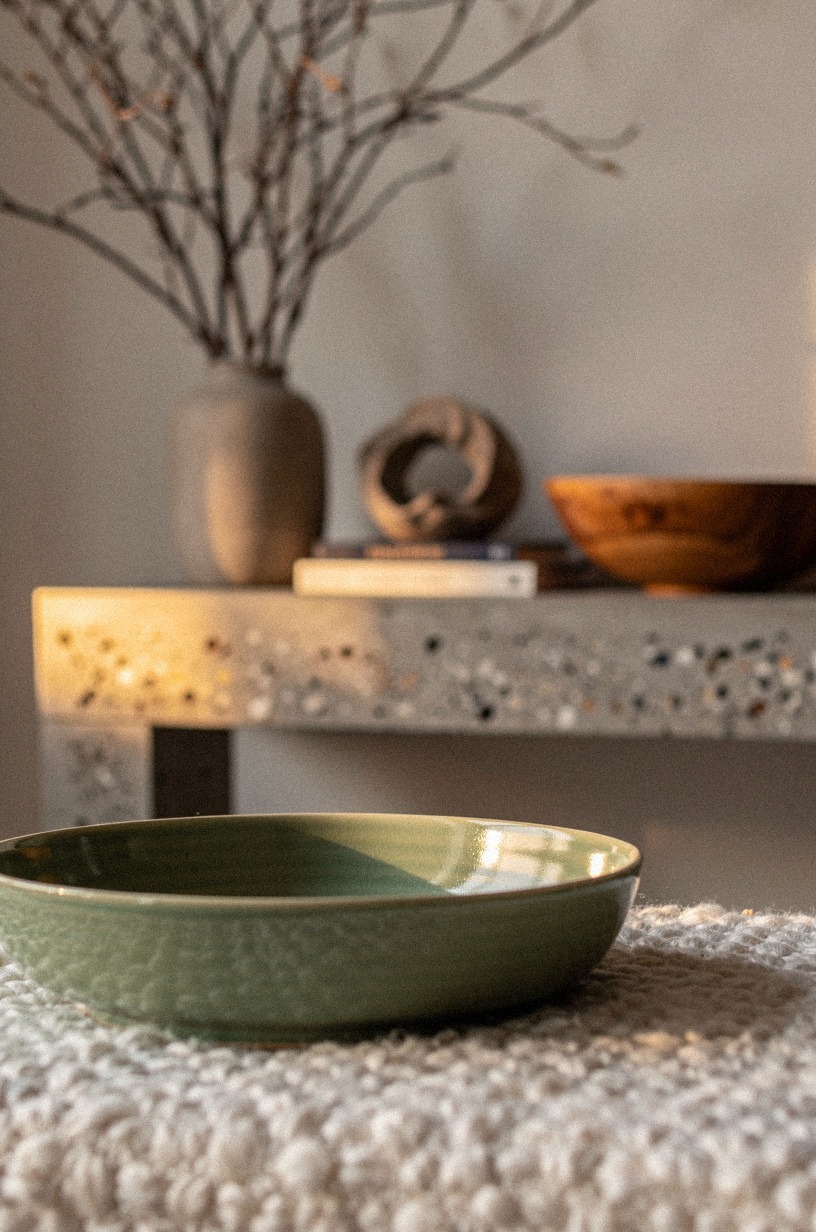 Balance a tall branch arrangement with bowls