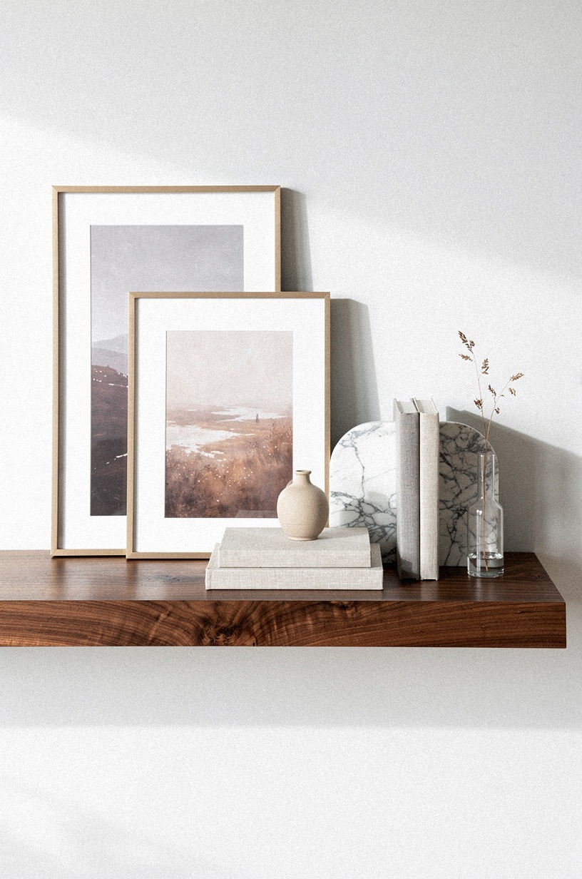 Layer small landscapes behind marble bookends