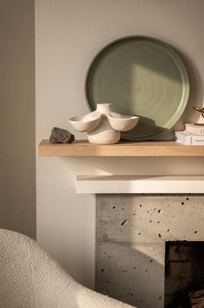 Lean a round tray behind sculptural pottery