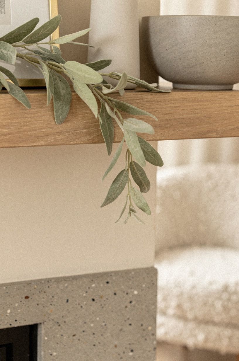 Drape simple greenery under the mantel lip