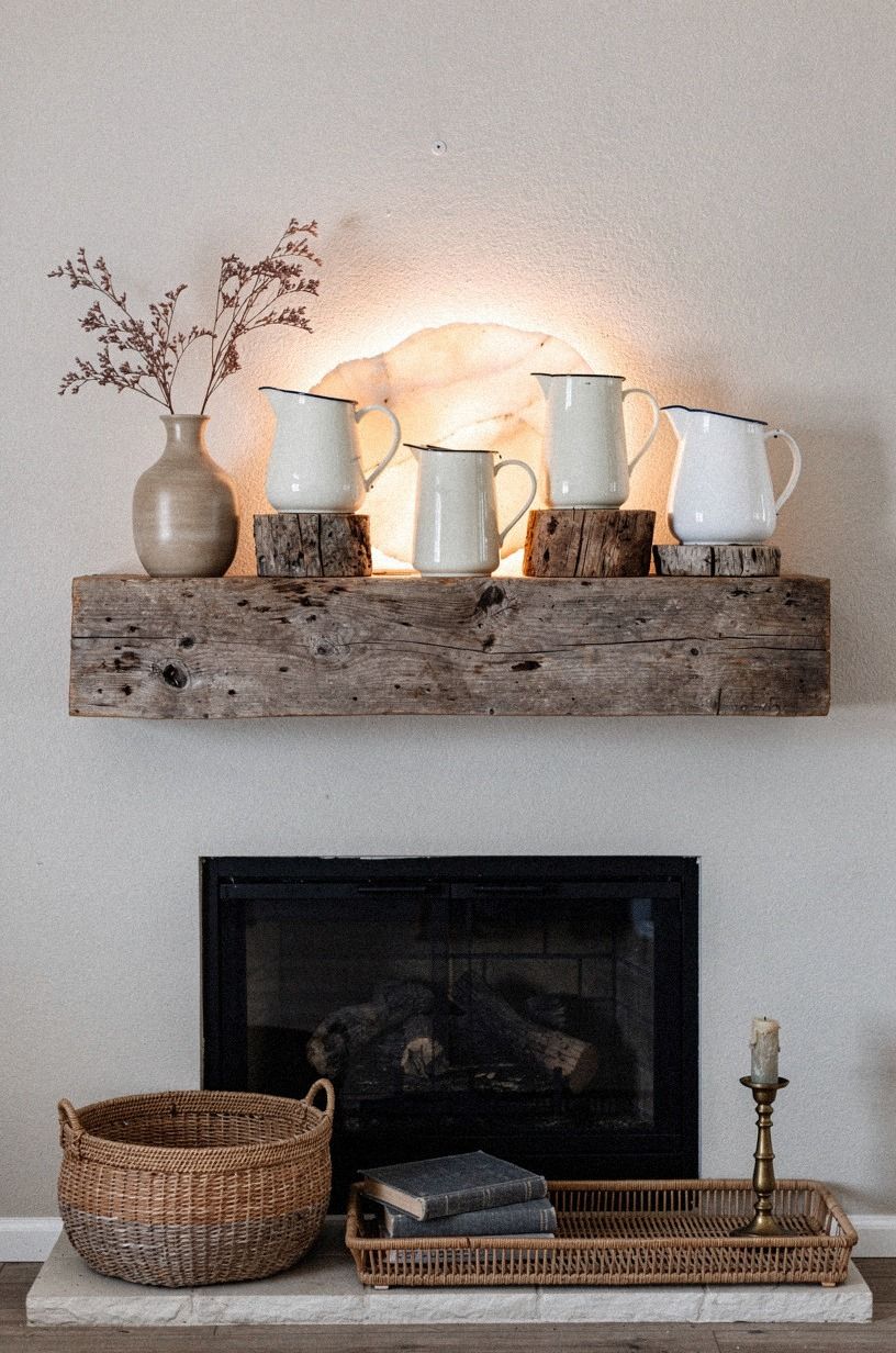 Pair enamel pitchers with weathered wood risers