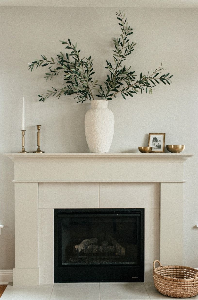 Center a plaster vase with olive branches