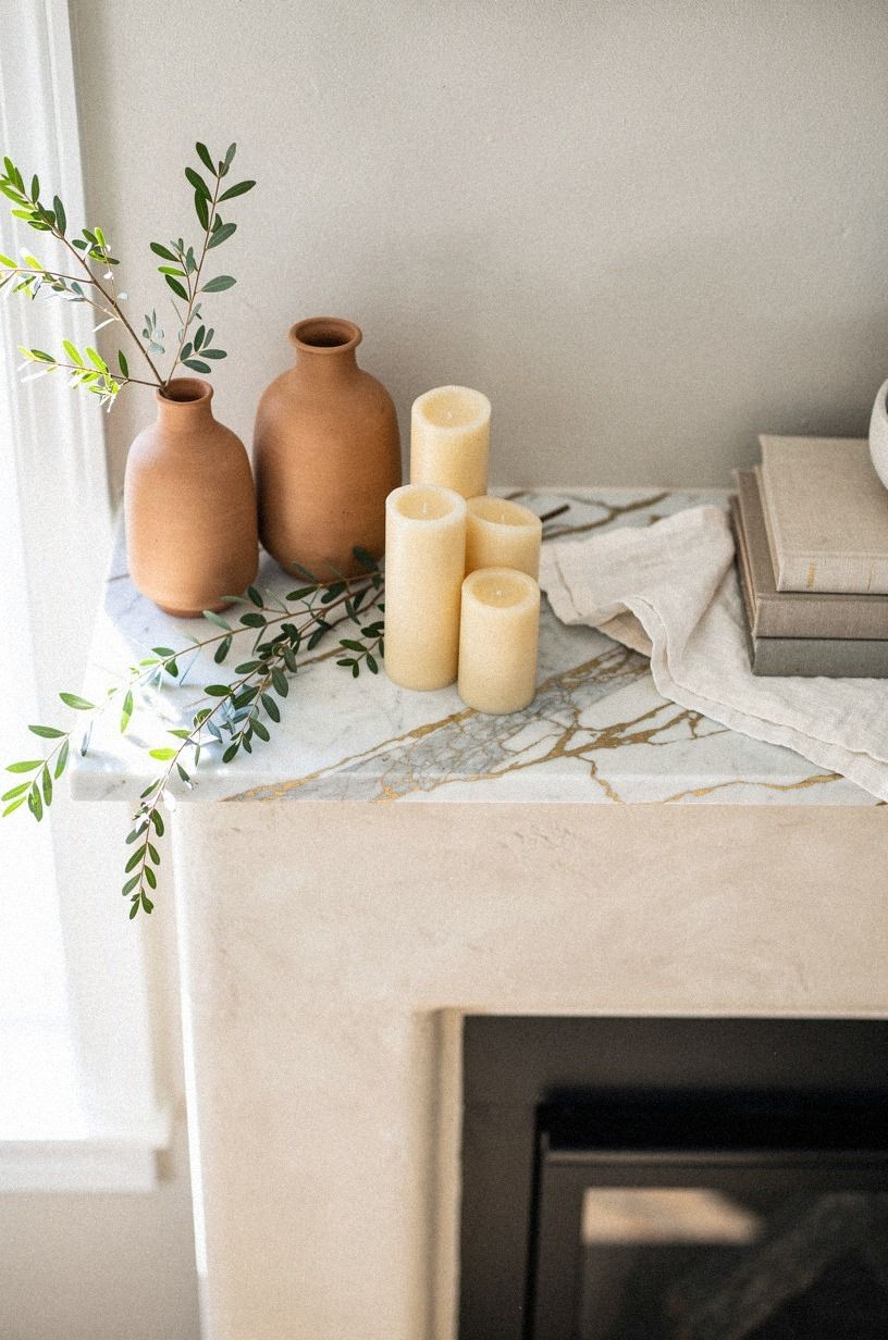 Arrange clay jugs beside warm pillar candles