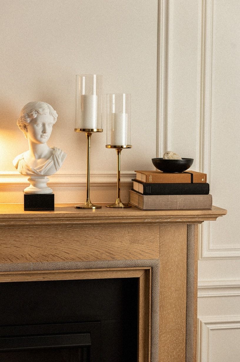 Placed a marble bust beside brass hurricanes