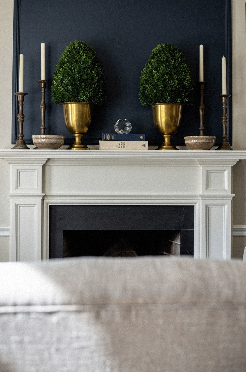 Tucked boxwood topiaries into brass cachepots