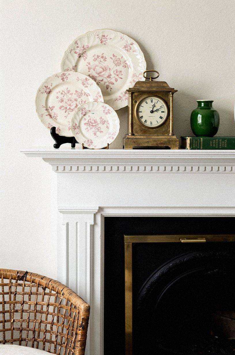 Cluster rose chintz plates around a mantel clock