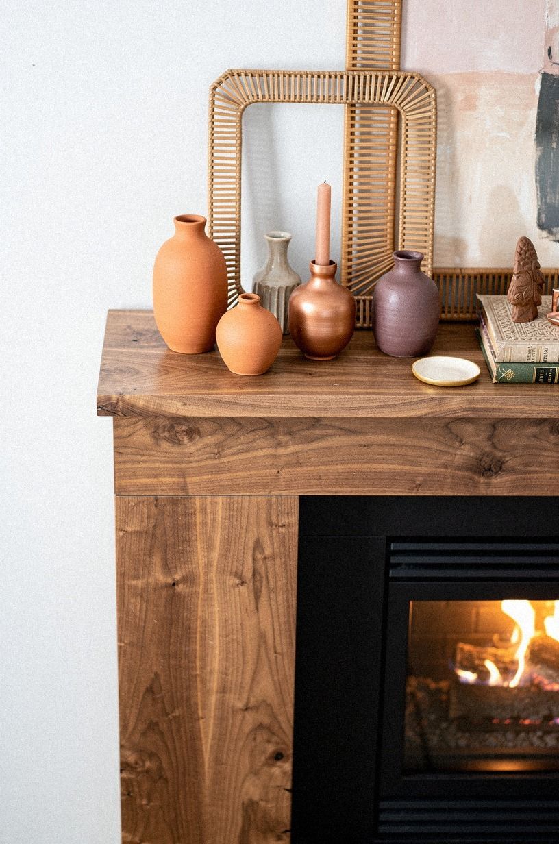 Layer rattan frames behind terracotta vases