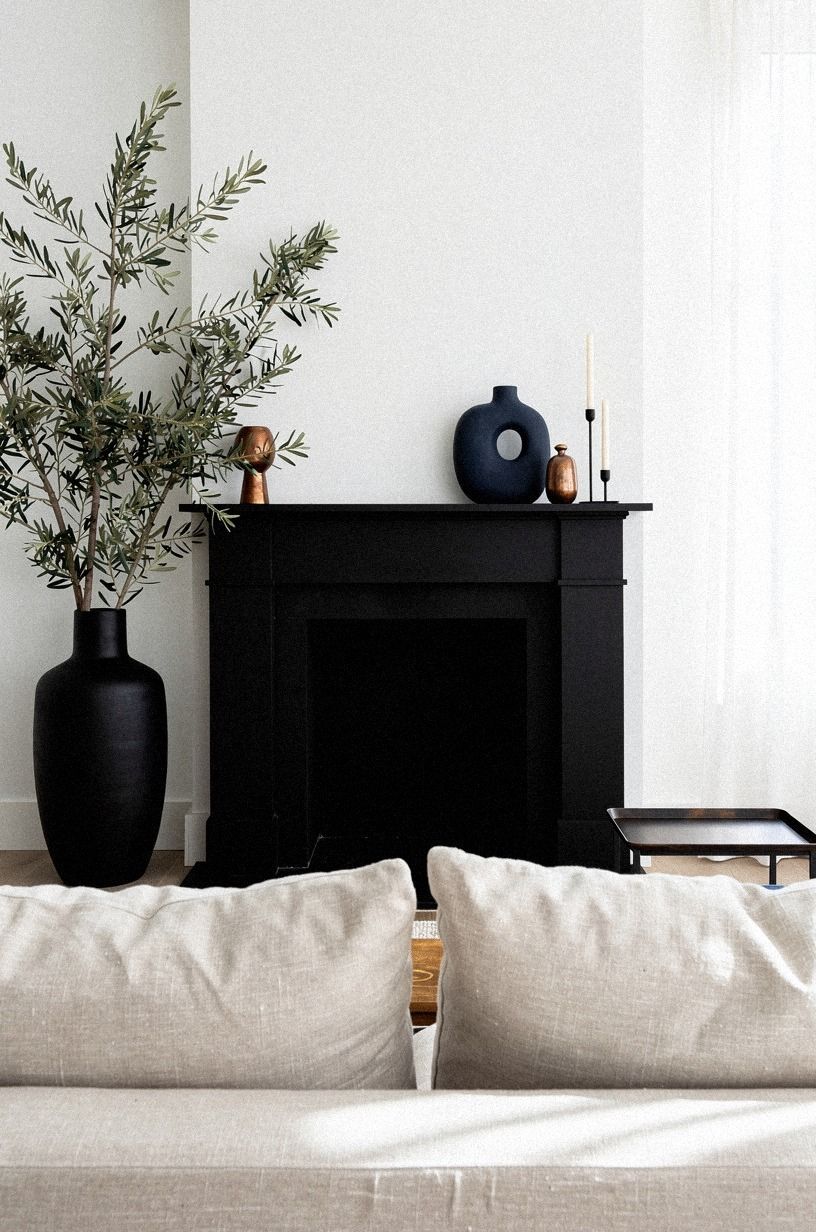 Layered olive branches in a black vase