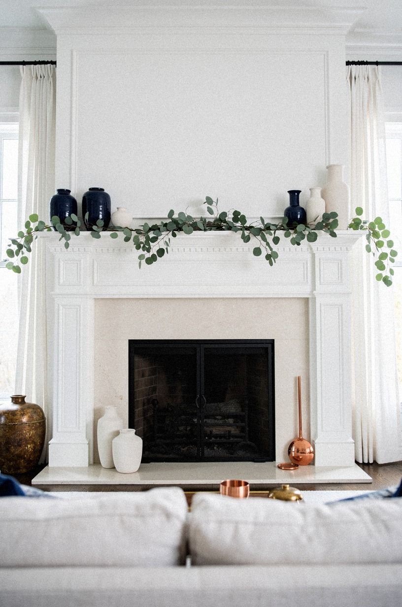 Drape soft eucalyptus under the mantel lip