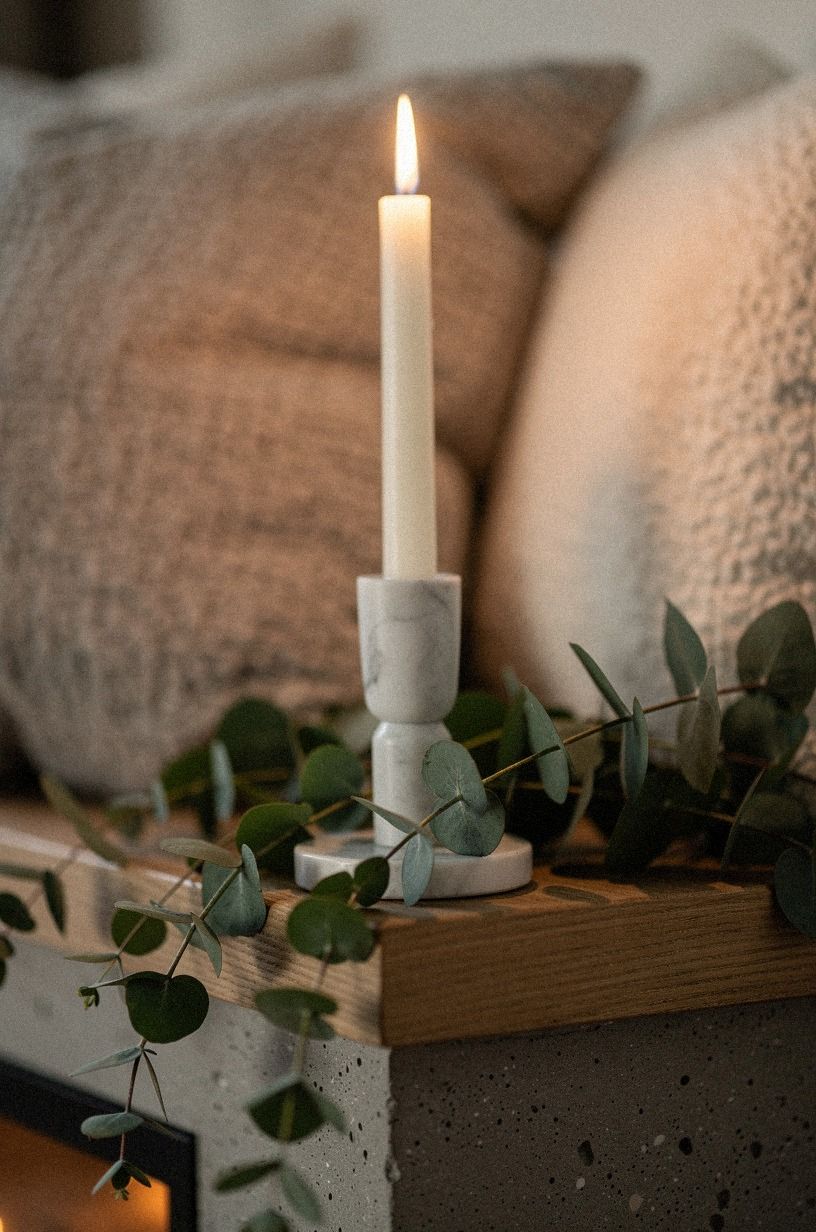 Pair marble tapers with trailing eucalyptus