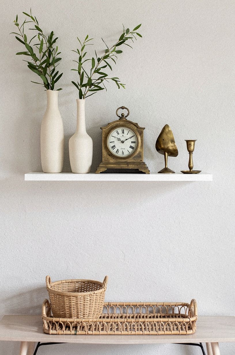 Build height with tall vases beside the clock