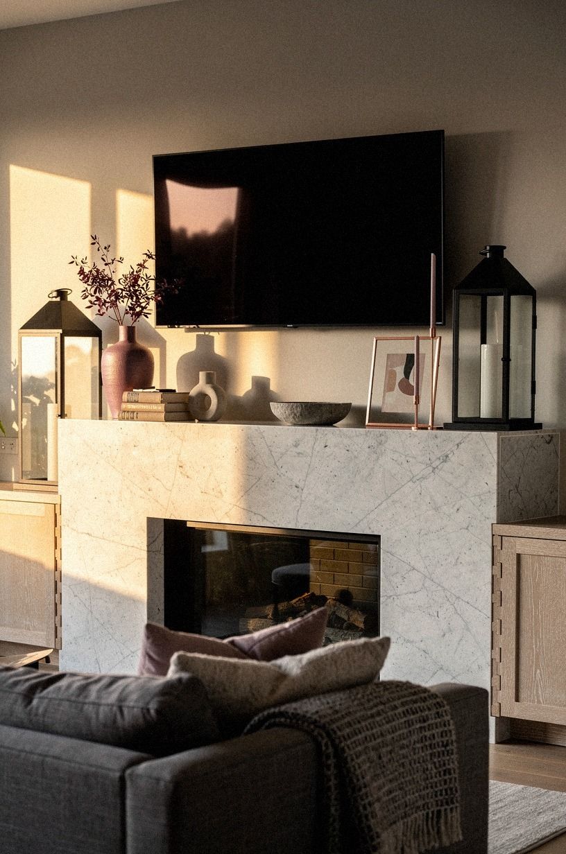 Anchor the surround with tall black lanterns