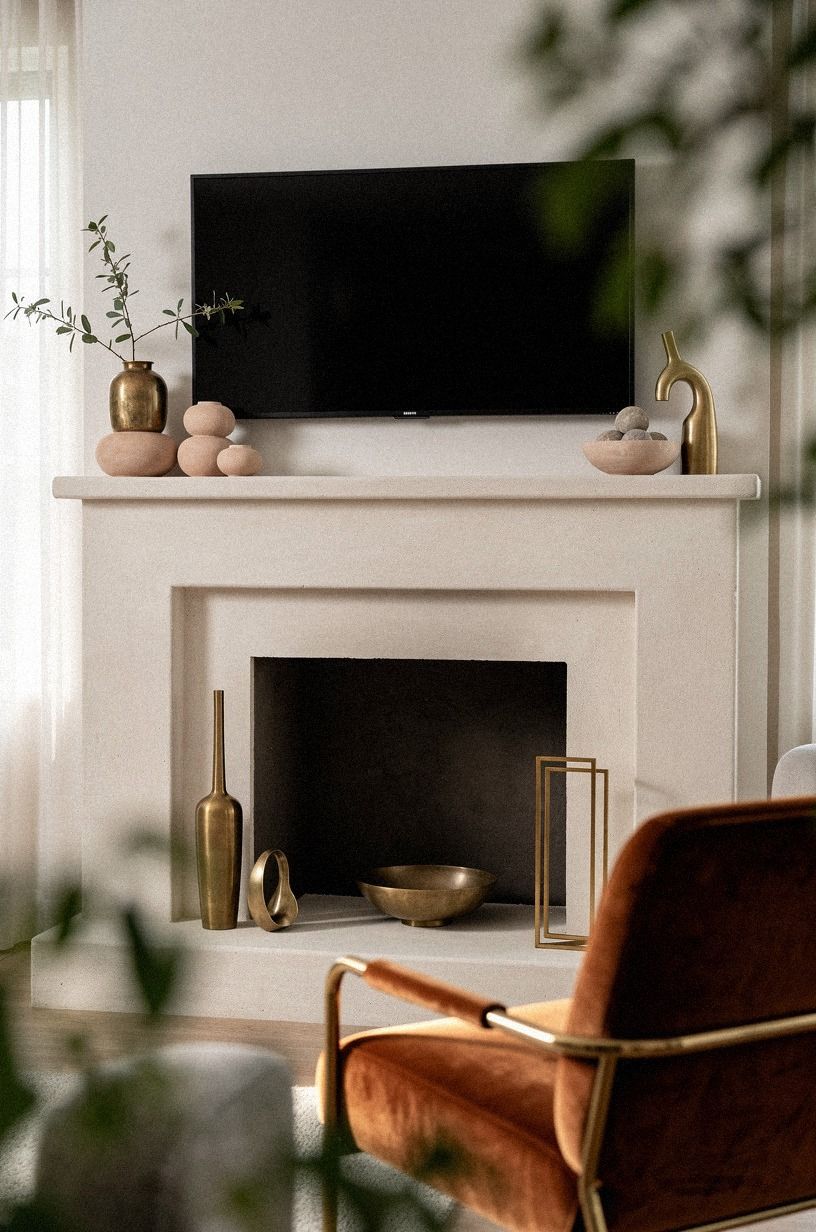 Repeat brass accents on both fireplace sides