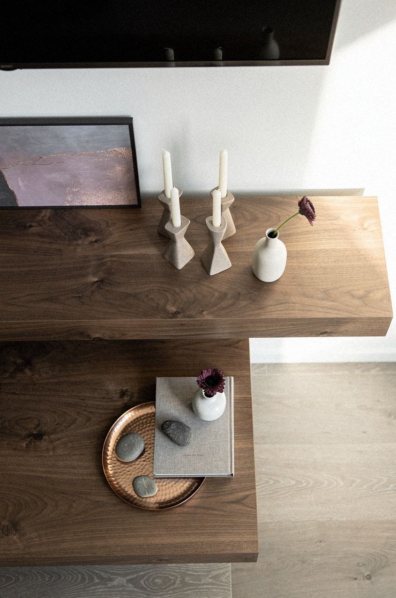 Nest a framed print behind low candlesticks
