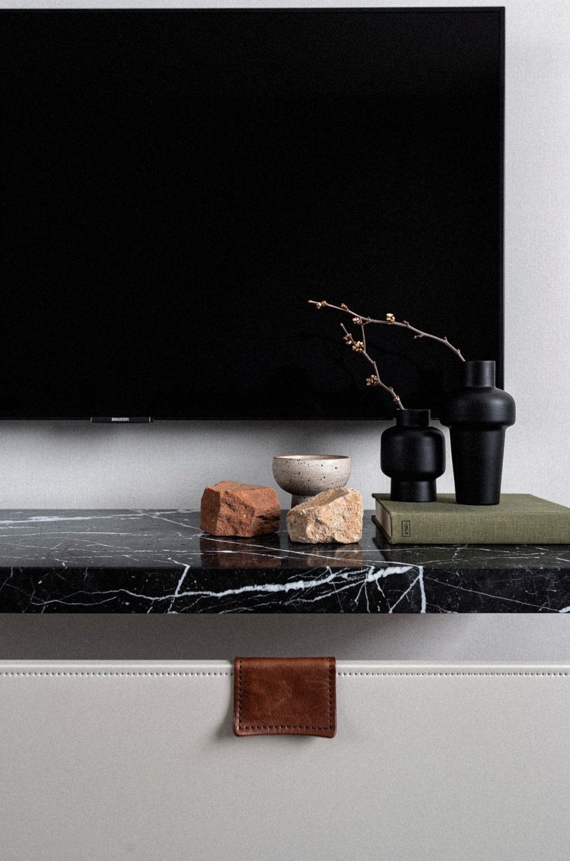 Place matte black vases near one end