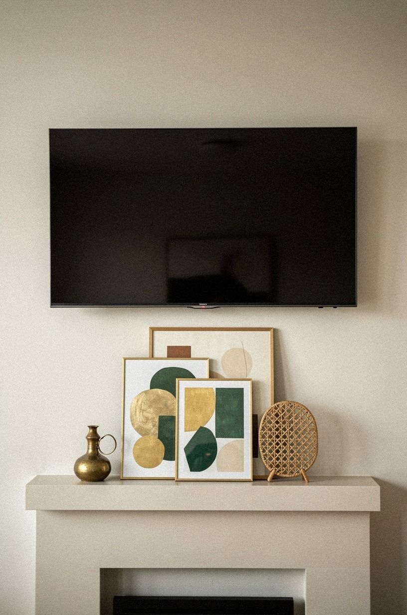 Layer low art beneath the TV bezel